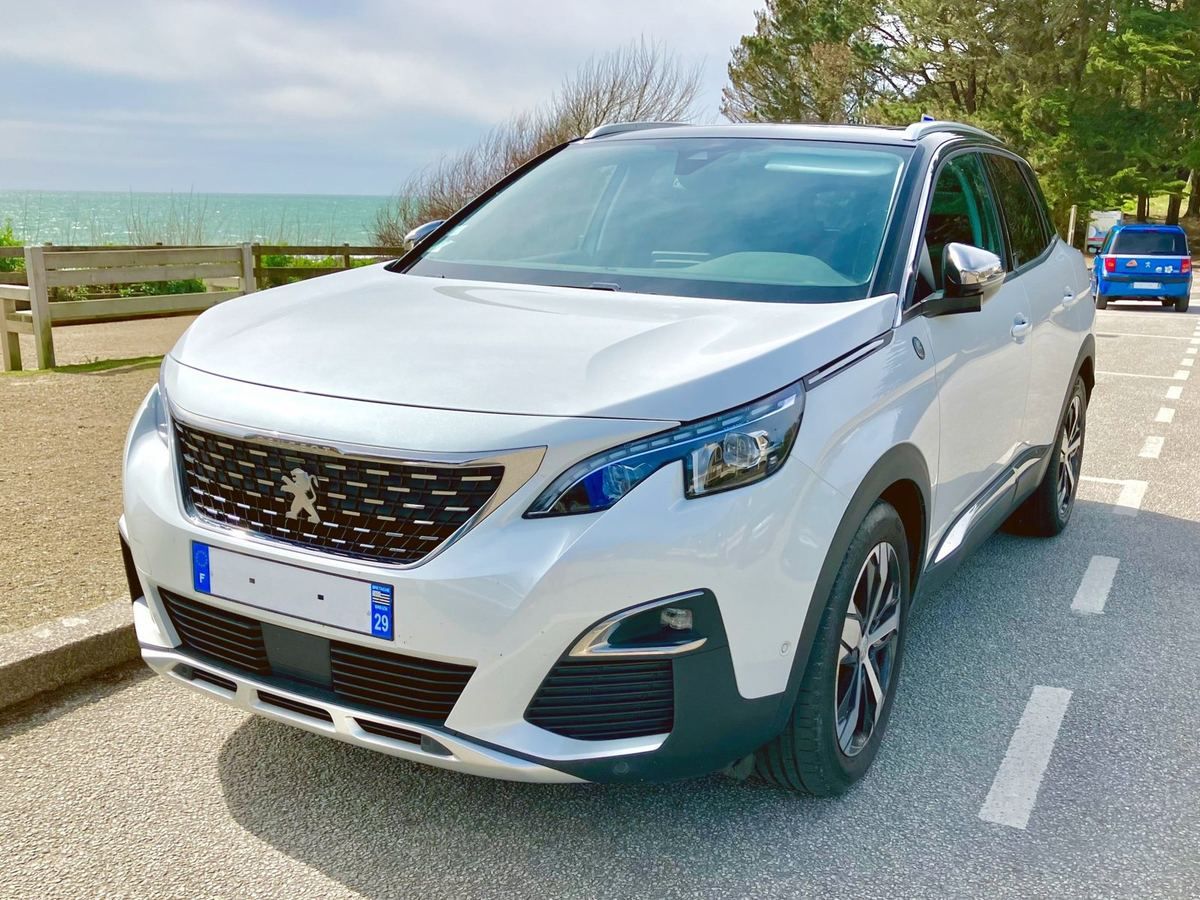 White Peugeot 3008 parked by the sea